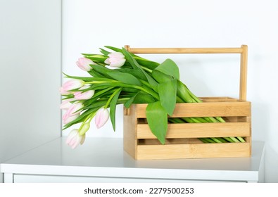 Bouquet of pink tulips in a wooden box on white background - Shutterstock ID 2279500253