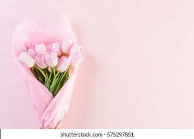 Bouquet of pink tulips wrappen in pink paper. - Shutterstock ID 575297851