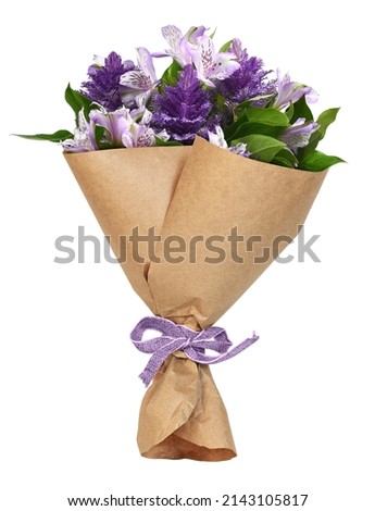 Bouquet of purple flowers in a craft paper wrapping cornet tied with canvas ribbon bow isolated on white