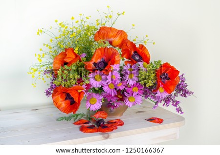 Bouquet with red poppies in a vase isolated on white background
