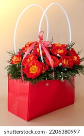 Bouquet Of Red Roses Decorated In Hat Box On Light Background. Tied Bow On Top. Flower Delivery Gift For Holiday. Flower Arrangement. Present Idea Greeting Card