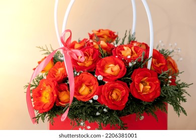 Bouquet Of Red Roses Decorated In Hat Box On Light Background. Tied Bow On Top. Flower Delivery Gift For Holiday. Flower Arrangement. Present Idea Greeting Card