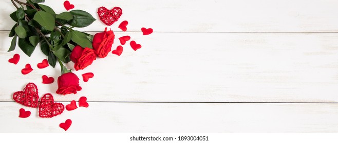 Bouquet of red roses and hearts on white background. Valentine's day, banner format. Place for text.