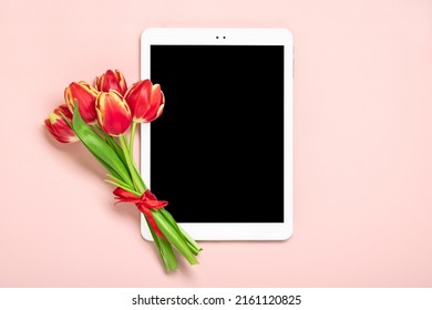 Bouquet of red tulip flowers and tablet with black digital screen on pink background Floral holiday card Top view Flat lay Happy Mother's, Valentine's, Women's Day, Flower shop concept Mock up - Powered by Shutterstock