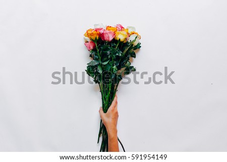 A bouquet of roses in his hand on a white background