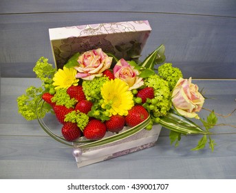 bouquet of roses and strawberries in a box