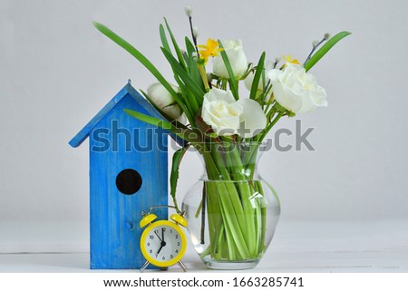 bouquet of spring flowers and a bright blue birdhouse on a pink background. picture for packages.Spring mood. Spring card for Mother's Day, Women's Day. Template greeting card .copy space.