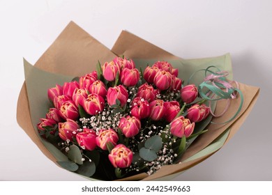 Bouquet of spring tulips with different color flowers wrapped in paper for present isolated on white background - Powered by Shutterstock