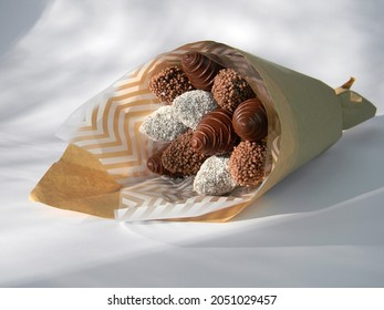 Bouquet of Strawberries in icing, covered with chocolate on a wheit background, an edible bouquet, Holiday concept for men      