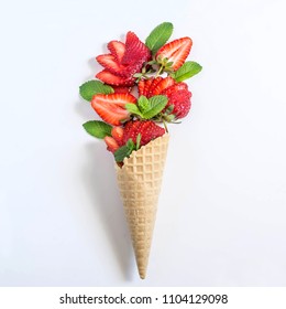 Bouquet of strawberries and mint in waffle cone. Minimal style. Concept of delicious summer desserts
