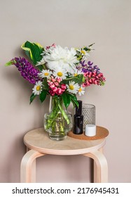 Bouquet Of Summer Flowers, Cosmetics, Candle On The Bedside Table