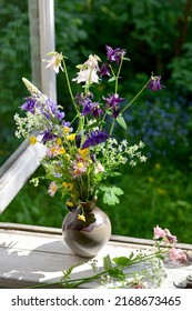 Bouquet Of Summer Wildflowers In A Vase On A Wooden Window Sill. Still Life On The Window Of An Old Country House, Summer Cottage.