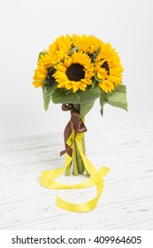Bouquet of sunflowers on white wooden background
