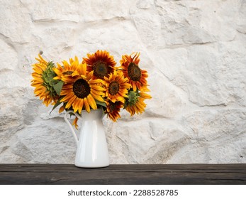 Bouquet of sunflowers in white vase with stone bottom - Powered by Shutterstock