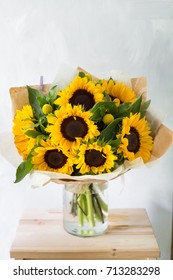 Bouquet of sunflowers and wild flowers on wooden table, copy space - Shutterstock ID 713283298