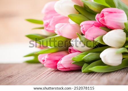 bouquet of tulips in front of spring scene