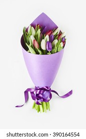 Bouquet Of Tulips Wrapped In Purple Paper Isolated