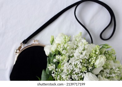 Bouquet Of White Lilac And Lisianthus Flowers And Black Velvet Bag