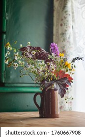 A Bouquet Of Wild Flowers Inside An Old Cottage
