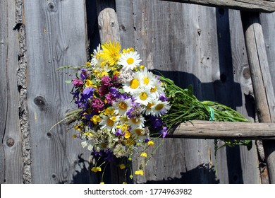 a bouquet of wildflowers lie on a wooden old staircase