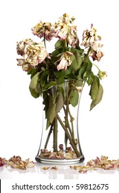Bouquet of withered roses in glass vase.