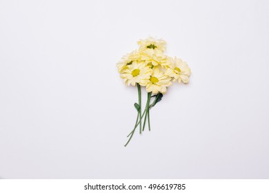 Bouquet Of Yellow Flowers On A White Table Top View