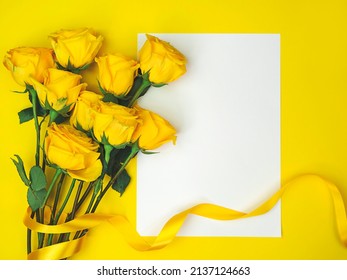 Bouquet of yellow roses on yellow background with space for text.