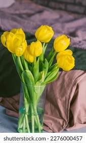 A bouquet of yellow tulips in a glass vase. Closeup. - Shutterstock ID 2276000457