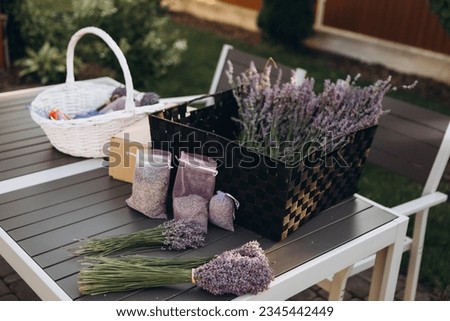 Bouquets of fresh lavender and bags with dried lavender on table