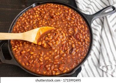 Bourbon Baked Beans in a Cast Iron Skillet: Pork and beans seasoned with bourbon whiskey, molasses, and brown sugar - Shutterstock ID 1715992495