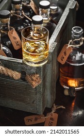 Bourbon With Ice In A Glass In The Distillery. Aged Cognac In Old Distillery Warehouse.