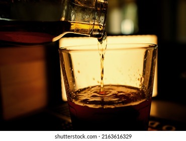 Bourbon Pouring Over A Rocks Glass