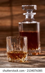 Bourbon Or Scotch In A Classy Decanter And A Beautiful Glass On A Wooden Board