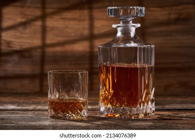 Bourbon Or Scotch In A Classy Decanter And A Beautiful Glass On A Wooden Board