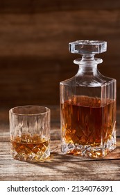 Bourbon Or Scotch In A Classy Decanter And A Beautiful Glass On A Wooden Board