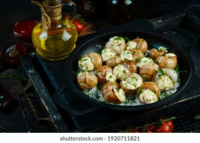 Bourgogne Escargot Snails With Garlic, Cheese In A Creamy Sauce On A Black Stone Plate. Top View. Free Space For Text.