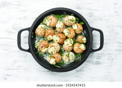 Bourgogne Escargot Snails With Garlic, Cheese In A Creamy Sauce On A Black Stone Plate. Top View. Free Space For Text.