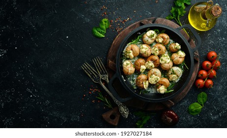 Bourgogne Escargot Snails With Garlic, Cheese In A Creamy Sauce On A Black Stone Plate. Top View. Free Space For Text.