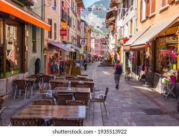 Bourg-Saint-Maurice, France - August 29, 2015: The main street of the old town with shops, restaurants, and tourists. 
