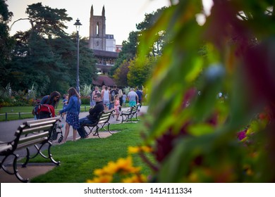 Bournemouth, Dorset / UK - August 21 2018: Happy Family People At Popular Lower Gardens Park - Famous And Unique Attraction, Halo Nightclub In Converted Old Church In The Background.                  