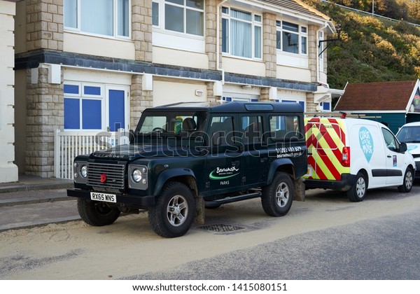 Bournemouth, Dorset / UK - May 2019: Bournemouth Borough\
Council Park Maintenance Vehicle, Famous Vintage Land Rover\
Defender at Tourist Information Office on the Beach.               \
               