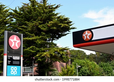 Bournemouth, England - June 2021: Signs outside a petrol filling station operate by the Co-op and supplied by the Texaco oil company