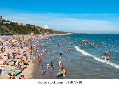 BOURNEMOUTH, ENGLAND, UK - JULY 27, 2008: Crowds of people on the beach on summer day in Dorset, England