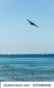 BOURNEMOUTH, UK - AUGUST 31, 2013: B 17 Flying Fortress Over Swimmers In Sea During Bournemouth Air Festival 2013.