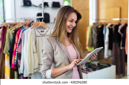 Boutique Owner Using A Digital Tablet
