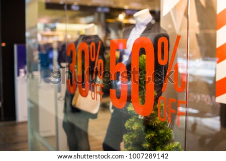 Boutique and Sale sign.Shop window display in the post about sales.announcement of a fifty-percentage discount on a glass show-window.shopping and discount concept. 