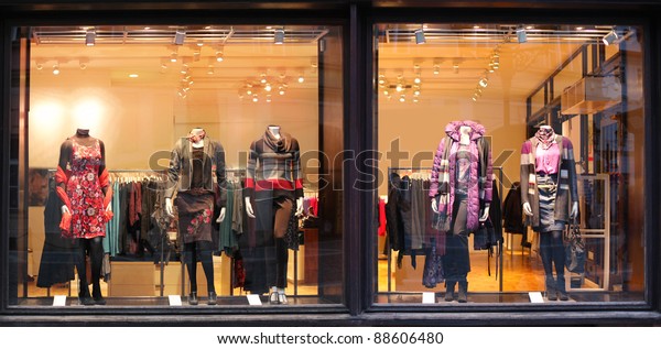 Boutique window with\
dressed mannequins