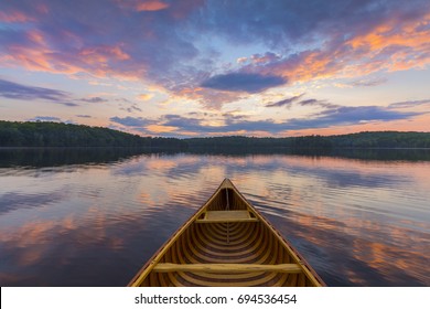 Bow Of A Cedar Canoe On A Lake At Sunset - Haliburton, Ontario, Canada