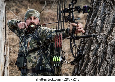 bow hunter drawn back shooting