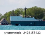 The bow of a lake freighter crashing through the waves on its trip up the St Clair River near Sarnia Ontario